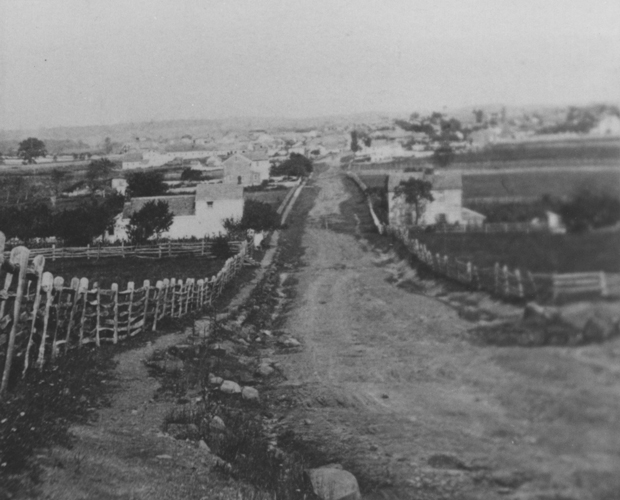 At the time of the battle, most of Pennsylvania was rural, with a few industrial towns and cities sprinkled throughout the commonwealth. Running as a swath through the southern segment of the state, paths and roads formed trade corridors that had radiated from Philadelphia since the state's earliest days. Bound largely to nearby York and Harrisburg by these trade routes, Gettysburg's farmers dispersed their products. The road network made Gettysburg unique from other communities and also brought the men and materiel for battle. While the passageways were in no way smooth, they did make Gettysburg a uniquely accessible community. This view of Gettysburg is looking south on Baltimore Street after the battle, ca. 1863–1870s. Photograph by Charles and Isaac Tyson. Source: Gettysburg National Military Park Archives.