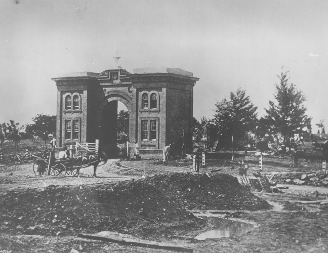 A source of pride before the battle, Ever Green Cemetery (established in 1854) had only recently opened on the significant swell of land that lay south of the town of Gettysburg’s boundary. The cemetery’s grand gatehouse was marked by a brick building that doubled as a home to its caretakers, the first of whom were PeterThorn, who became the superintendent of the cemetery in 1856, and his wife, Elizabeth. After Peter joined Company B of the 138th Pennsylvania infantry, Elizabeth served as caretaker from 1862–1865. Once Cemetery Hill became the center of the Union line, it also became the focus of intense fighting, and Elizabeth abandoned the gatehouse, which was then used as a headquarters by Union leaders. In the weeks following the battle, Elizabeth, while six months pregnant, and her father dug graves and buried ninety-nine soldiers in the rockiest portions of the cemetery. In this photograph by Alexander Gardner on July 7, 1863, the earthen fortifications remain but the building’s windows do not. Source: Gettysburg National Military Park Archives.