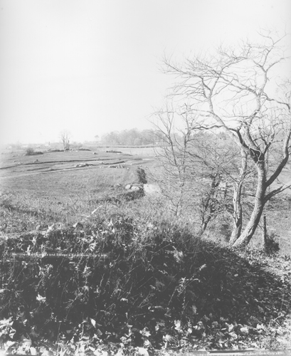 The Union earthworks of Brigadier General James Wadsworth’s First Division, I Corps, with tourism development already visible at Culp’s Hill in the distance. Photograph by William H. Tipton, ca. 1888–1889. Source: Gettysburg National Military Park Archives.
