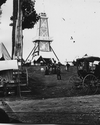 The concept of an overlook (a “bird’s-eye view”) was familiar to field generals and tourists alike. For this reason, entrepreneurs and preservationists added towers to many areas of the battlefield by the 1870s. One Tipton photo shows the observatory on East Cemetery Hill during the Grand Army of the Republic’s Encampment in 1880.  Source: Gettysburg National Military Park Archives.