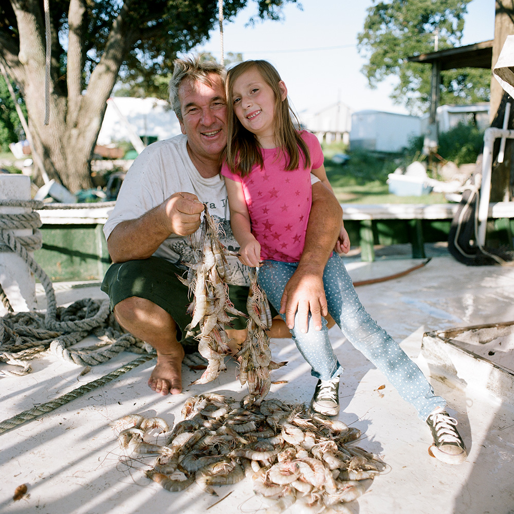 Commercial shrimper Charles Robin III and granddaughter, Anna Lee Robin, in Yscloskey, 2015.