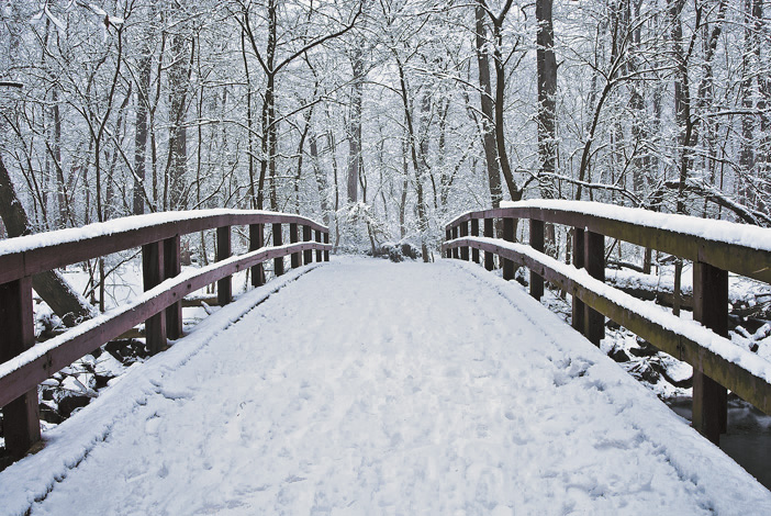 Boundary Bridge with footprints in the snow. (© Susan Austin Roth)