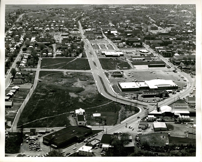 Harrisonburg Redevelopment and Housing Authority, aerial view of Urban Renewal areas north of downtown, ca. 1965. Photographer unknown. This photograph was taken by the city’s Redevelopment and Housing Authority to document the “progress” being made to encourage commercial development by widening arteries such as U.S. 11 (bottom and right) and North Mason Street (center) and leveling traditional working-class neighborhoods (lower left).
