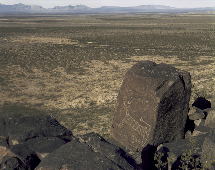 January 10, 1983. Prehistoric Native American petroglyphs and pictographs, unlike the subjects in most of the photographs in this book, are not usually found along roads but in the open landscape or along trails. They are most often on south-facing rocks or cliff walls, many times at locations with views or at the junction of two rivers. This petroglyph, probably more than 1,000 years old, has been described as a “jaguar with a rattlesnake tail” on an information kiosk at the Three Rivers petroglyph site in Lincoln County, New Mexico. It commands a view of the Oscura Mountains and, beyond them, the Jornada del Muerto and Trinity Site, where the world’s first nuclear explosion occurred on July 16, 1945.