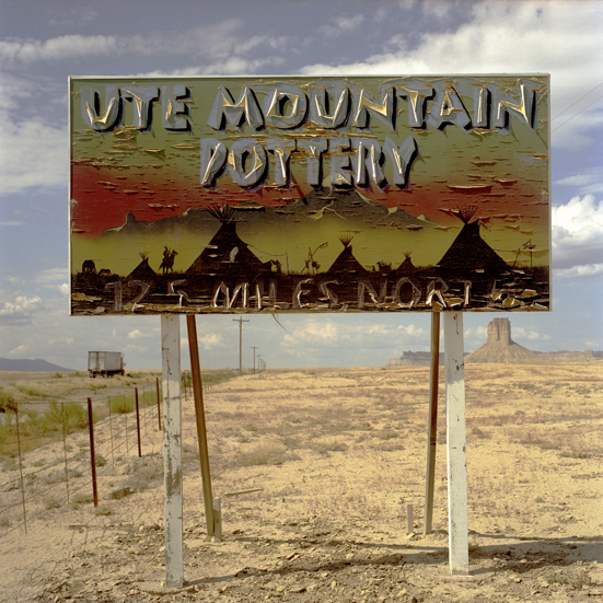 July 21, 2007. This photograph contains another double landscape on a sign along U.S. 491 on the Ute Mountain Ute Reservation south of Cortez, Colorado, a magical landscape painted in silhouette with Ute Mountain floating in the sky above teepees. The problem with plywood signs outdoors is that they don’t weather well. But, as a result, they become more interesting as they age, acquiring character and a history. What does last? Unique motel signs made of neon and metal don’t either. Drive-in movie theaters don’t. Prehistoric Native American petroglyphs hand pecked into stone with simple tools, however, have done pretty well, especially in the dry Southwest. Many are several thousand years old.
