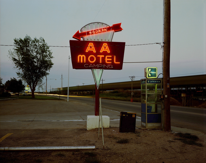 May 22, 1981. The AA “MODERN” Motel with “CAMPING” sits next to railroad tracks and U.S. 6 in Holdrege, Nebraska, which is located slightly east of the 100th meridian in central Nebraska, the line of demarcation for the West. The problem with using “modern” on a sign is that it is hard for the motel to keep up with the word. When I made this photograph I was on my way to Antigo, Wisconsin, to learn to bend neon.