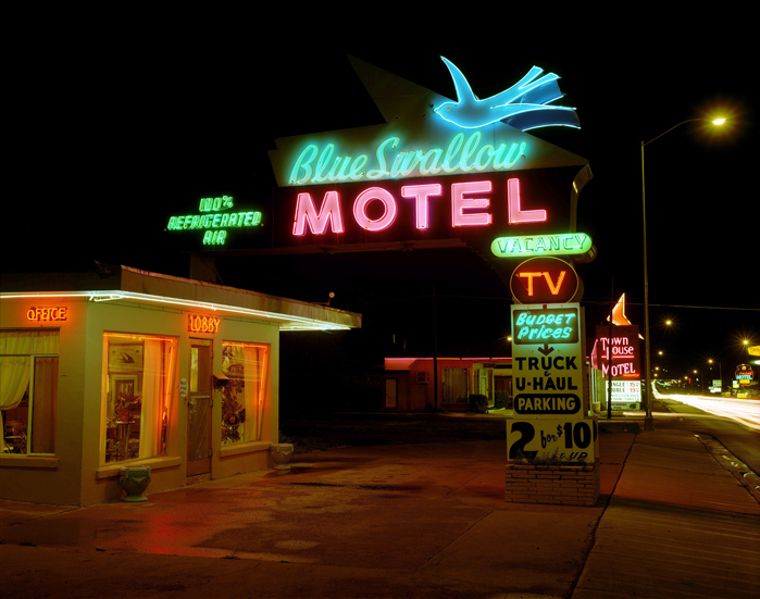 July 1990. The Blue Swallow Motel is located on U.S. 66 (aka Route 66) and survives in another one of my gateway towns, Tucumcari. It is the classic sign and motel by which all other Route 66 motels, from Chicago to Los Angeles, should be, and are, compared. Lillian Redman, the owner of the Blue Swallow who was in her 80s when I made this photograph, turned the motel’s office into a veritable museum of things Blue Swallow and Route 66. Her husband once made a painting of a blue swallow that was used as the template for the neon swallow; the painting is prominently displayed in the motel’s office. Lillian has died, but the Blue Swallow lives on in all of its glory, with a new series of owners who have taken pride in and maintained the sign and motel.