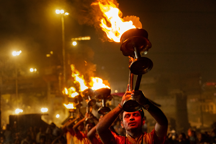 Priests at the Dasaswamedh aarathi hold their diyas aloft.