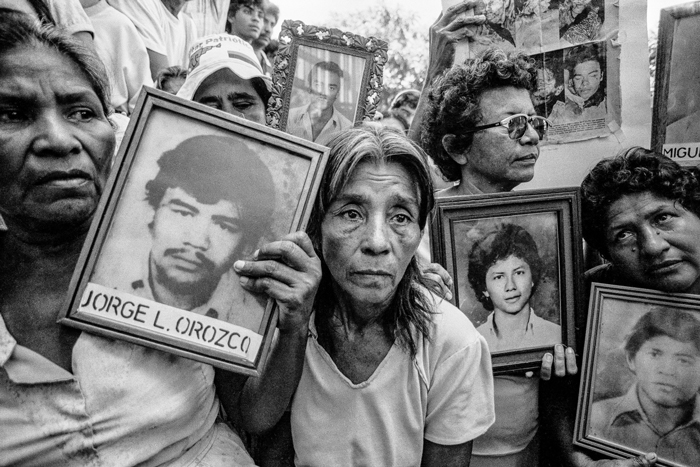 Women gather in Managua to protest U.S. support for the Contra rebels, holding photographs of loved ones killed in Contra attacks in the north and central war zones of Nicaragua, June 1987.
