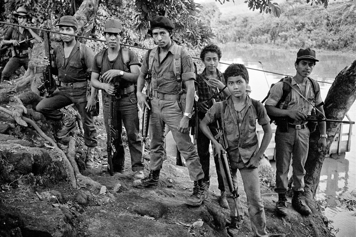 Fighters of an elite Farabundo Martí National Liberation Front (FMLN) guerrilla unit at a river crossing, Usulután Department, El Salvador, September 1983.
