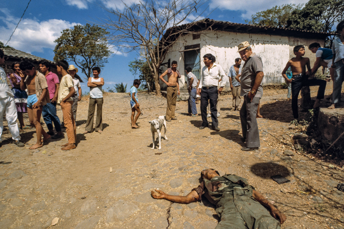 Villagers gawk at the body of a government soldier slain in an Election Day attack by FMLN guerrillas, San Francisco Javier, Usulután Department, El Salvador, March 1989.