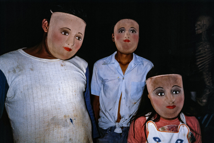 A craftsman and his children display theatrical masks used in folkloric dances in the front room of his shop, Masaya, Nicaragua, April 1984.