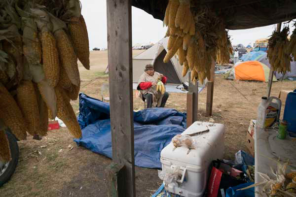 Winona outside her kitchen, one of more than a dozen community kitchens at camp that offered regular free meals. 