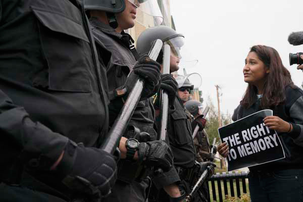 Pleading with police officers in Mandan.