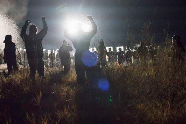 Water Protectors praying in front of the police line.