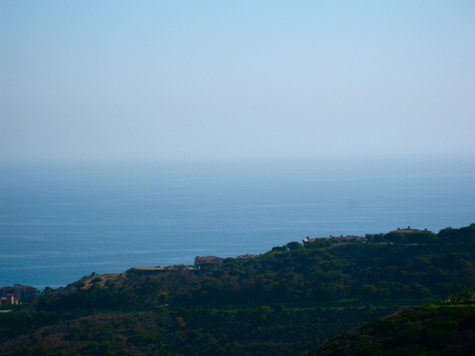 Ocean hillside with haze in the distance